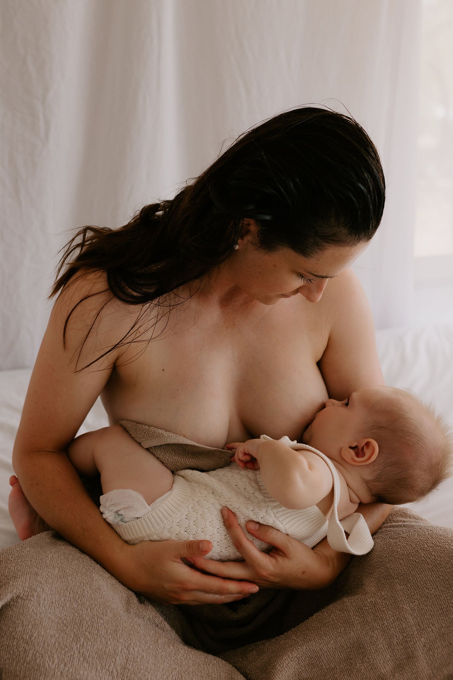 woman breastfeeding her small baby